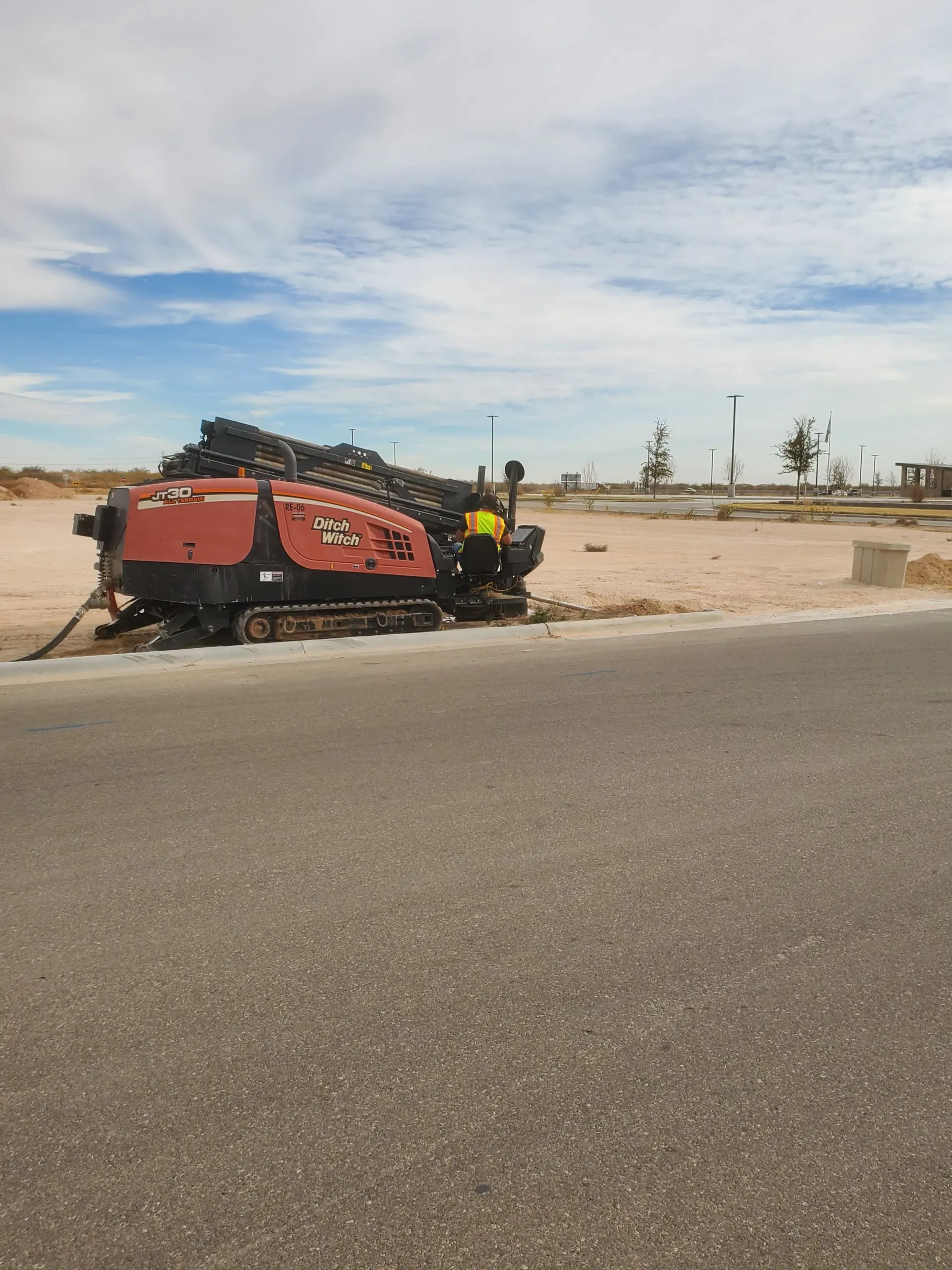 A directional drilling rig boring fiber conduit along a Monahans street during Phase I construction.